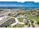 Beautiful aerial view of the community with lush landscaping, a pool, and ocean views at 618 Bird Bay S Dr # 113, Venice, FL 34285