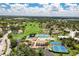 Aerial view of the community featuring manicured lawns, golf course, and residential buildings at 618 Bird Bay S Dr # 113, Venice, FL 34285