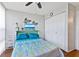 Inviting bedroom with ceiling fan, closet, and a mounted TV for relaxation at 618 Bird Bay S Dr # 113, Venice, FL 34285