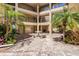 Exterior courtyard showcasing a table with benches and manicured landscaping at 618 Bird Bay S Dr # 113, Venice, FL 34285