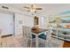 Charming dining area featuring a ceiling fan and a view of the kitchen at 618 Bird Bay S Dr # 113, Venice, FL 34285