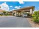 Exterior shot of a covered entrance with lush landscaping and clear signage at 618 Bird Bay S Dr # 113, Venice, FL 34285