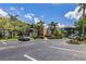 Exterior shot of the condo complex featuring well-maintained landscaping and ample parking at 618 Bird Bay S Dr # 113, Venice, FL 34285