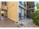 Building exterior showing well-maintained landscaping, stone pathway, and covered access to units at 618 Bird Bay S Dr # 113, Venice, FL 34285