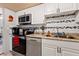 Well-lit kitchen with granite counters, stainless steel appliances, and white cabinetry at 618 Bird Bay S Dr # 113, Venice, FL 34285