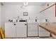 Laundry room with multiple washers and dryers for convenient resident use at 618 Bird Bay S Dr # 113, Venice, FL 34285