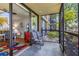 The screened porch offers an outdoor area with views of the living area and lush landscaping at 618 Bird Bay S Dr # 113, Venice, FL 34285