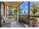 View from the screened porch to the landscaped yard and palm trees, perfect for relaxing outdoors at 618 Bird Bay S Dr # 113, Venice, FL 34285