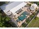 An aerial shot showcases this home's backyard oasis featuring a pool, sun loungers and tropical landscaping at 6180 42Nd N Ave, St Petersburg, FL 33709