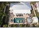 Aerial view showcasing a private backyard with pool, outdoor seating, and a manicured lawn at 6180 42Nd N Ave, St Petersburg, FL 33709