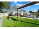 This backyard features a lawn, a swimming pool, and a built-in game area at 6180 42Nd N Ave, St Petersburg, FL 33709