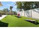 This backyard features an artificial lawn, a privacy fence, and a built-in game area at 6180 42Nd N Ave, St Petersburg, FL 33709