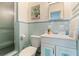 Charming bathroom featuring blue tile, a glass shower, and vintage fixtures at 6180 42Nd N Ave, St Petersburg, FL 33709