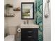 Cozy bathroom featuring a navy vanity, vessel sink, sleek mirror, and stylish shower curtain at 6180 42Nd N Ave, St Petersburg, FL 33709