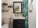 Updated bathroom featuring a modern vanity, shelving, a decorative shower curtain, and subway tile at 6180 42Nd N Ave, St Petersburg, FL 33709