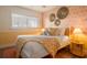 Cozy bedroom with warm color scheme, a queen-sized bed, and natural light from the window at 6180 42Nd N Ave, St Petersburg, FL 33709