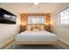 Bright bedroom featuring wallpaper, white linens, and a flat screen television at 6180 42Nd N Ave, St Petersburg, FL 33709