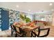 A dining room showcases a stylish table setting with a view into the open-concept living space at 6180 42Nd N Ave, St Petersburg, FL 33709