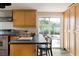 Kitchen with backyard pool view, stainless steel appliances, wood cabinets, and dark countertops at 6180 42Nd N Ave, St Petersburg, FL 33709