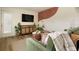 Living room featuring a cozy green armchair, a wall mural, and hardwood floors at 6180 42Nd N Ave, St Petersburg, FL 33709