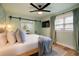 Spacious and bright main bedroom with a decorative ceiling fan, light walls, and matching curtains at 6180 42Nd N Ave, St Petersburg, FL 33709