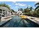 Backyard featuring a pristine pool, poolside seating, and a lush tropical landscape at 6180 42Nd N Ave, St Petersburg, FL 33709
