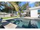 This backyard features a small inground pool, patio furniture, and a built-in game area at 6180 42Nd N Ave, St Petersburg, FL 33709