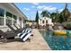 Relaxing backyard featuring a sparkling pool, lounge chairs, and outdoor seating area at 6180 42Nd N Ave, St Petersburg, FL 33709