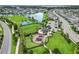 Aerial view of the community park featuring a playground, splash pad, and lake at 6256 Springmont Loop, Palmetto, FL 34221
