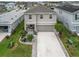 Aerial view of the home showing the lush landscaping and driveway at 6256 Springmont Loop, Palmetto, FL 34221