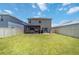 Back yard with covered patio, playground, and large lawn area at 6256 Springmont Loop, Palmetto, FL 34221