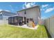 The back yard features a covered patio, play set, and a well manicured lawn at 6256 Springmont Loop, Palmetto, FL 34221