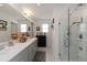 Bathroom featuring a double sink vanity, large mirror, and glass shower at 6256 Springmont Loop, Palmetto, FL 34221