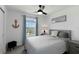 Bedroom with a gray bed, neutral walls, ceiling fan, and ample natural light at 6256 Springmont Loop, Palmetto, FL 34221
