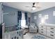 Cozy bedroom features blue walls, gray furniture, and decorative wall art at 6256 Springmont Loop, Palmetto, FL 34221