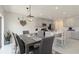 Open-concept dining area with gray dining table set and modern lighting fixture adjacent to the kitchen at 6256 Springmont Loop, Palmetto, FL 34221