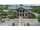 An inviting exterior view of the clubhouse with stone pillars and lush landscaping at 6256 Springmont Loop, Palmetto, FL 34221