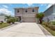 Charming two-story home with a well-maintained lawn and an inviting two car driveway at 6256 Springmont Loop, Palmetto, FL 34221