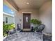 Inviting front porch with stylish seating and decor, creating a welcoming entrance at 6256 Springmont Loop, Palmetto, FL 34221