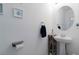 Elegant half bathroom featuring a pedestal sink and decorative wall art at 6256 Springmont Loop, Palmetto, FL 34221