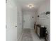 Bright hallway with neutral tones and stylish decor, leading to the main living areas at 6256 Springmont Loop, Palmetto, FL 34221