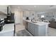 Contemporary kitchen featuring gray cabinets, stainless steel appliances, and a functional center island at 6256 Springmont Loop, Palmetto, FL 34221