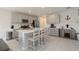 Bright kitchen with gray cabinetry, stainless appliances, and large center island with bar stool seating at 6256 Springmont Loop, Palmetto, FL 34221