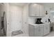 Compact kitchenette area with gray cabinets, countertop appliances, and easy access to storage at 6256 Springmont Loop, Palmetto, FL 34221