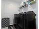 Well-organized laundry room with modern black washer and dryer, with a patterned ottoman at 6256 Springmont Loop, Palmetto, FL 34221