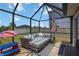 Relaxing screened patio featuring comfortable seating and outdoor decor at 6256 Springmont Loop, Palmetto, FL 34221