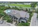 A stunning aerial view of the community clubhouse and pool with ample seating and lush surroundings at 6256 Springmont Loop, Palmetto, FL 34221