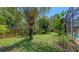 Green backyard with lush vegetation and a wooden fence at 626 46Th St, Sarasota, FL 34234