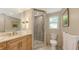 Bathroom featuring marble countertops, and a glass-enclosed shower with neutral color palette at 626 46Th St, Sarasota, FL 34234