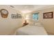 Cozy bedroom featuring neutral tones and ample natural light from the window at 626 46Th St, Sarasota, FL 34234